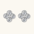 Dainty sterling silver quatrefoil stud earrings with four brilliant moissanite stones and center accent on white background.